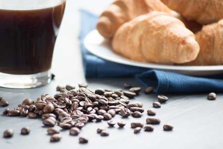 Coffee cup and fresh baked croissants on wooden background. Top View.の写真素材