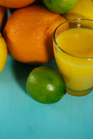 Fruit of citrus, orange, lime, lemon, pomelo, grapefruit with orange juice in a glass of glassの写真素材