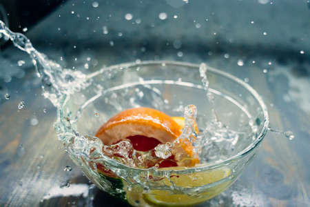 tropical fruits citrus fall deeply under water with a big splashの写真素材