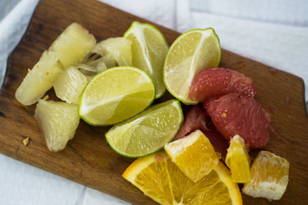 stack of citrus fruits slices. Oranges and lemons limes, grapefruit, pomelo. On wooden tableの写真素材