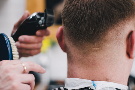 Barber cuts the client mac Haircut men Barbershop. Men's Hairdressers; barbers.