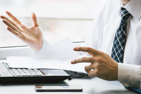 Young businessman sitting behind crumpled paper expectations Emotionの写真素材