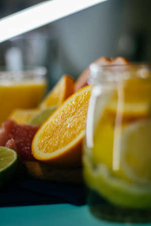 Citrus, oranges, lemons, limes, grapefruit, pomelo on vintage board lemonade on a turquoise backgroundの写真素材