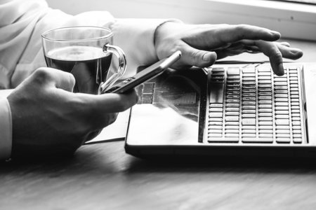 Business  using laptop computer and mobile smart phone at home commerce or online working from home,...