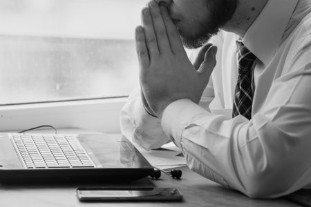 Young businessman sitting behind crumpled paper expectations Emotion