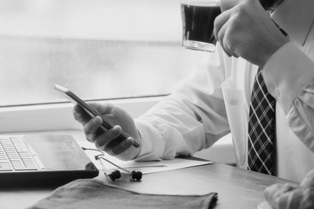 Young businessman with smartphone in cafe