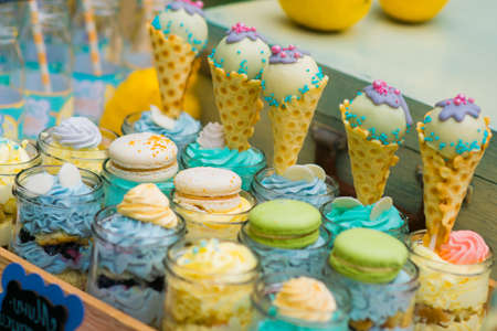 Details of a tasty candy bar with jugs of sweets, cookies and marshmallowsの写真素材