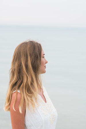 woman in a white dress on the ocean coast