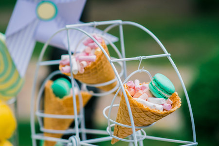 Details of a tasty candy bar with jugs of sweets, cookies and marshmallowsの写真素材