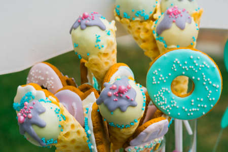 Details of a tasty candy bar with jugs of sweets, cookies and marshmallowsの写真素材