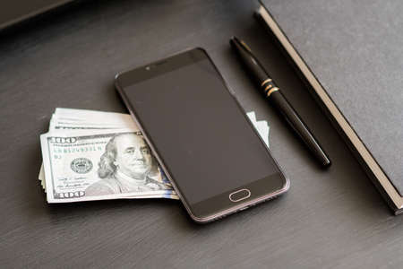 Smartphone with coffee on wooden tableの写真素材