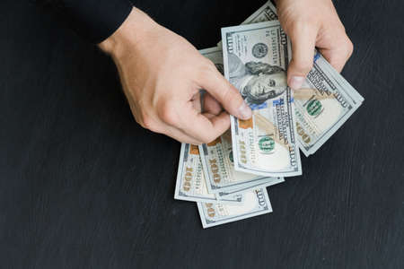 hand recount dollars. the man counts the money. new hundred-dollar billsの写真素材