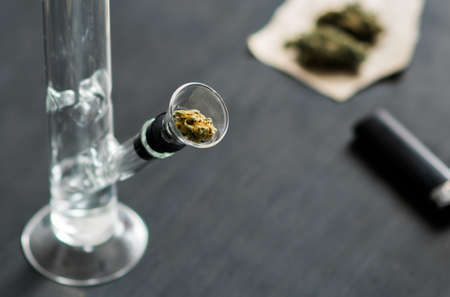 Bong and marijuana, cannabis thc flower Sativa and Indica Close up on a black background. lifestyle Concepts the legalization of marijuana in the world and the United States.の写真素材