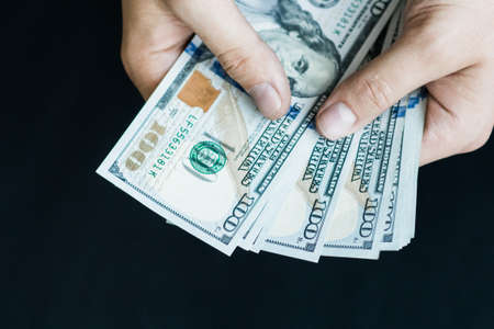 hand recount dollars. the man counts the money. new hundred-dollar billsの写真素材