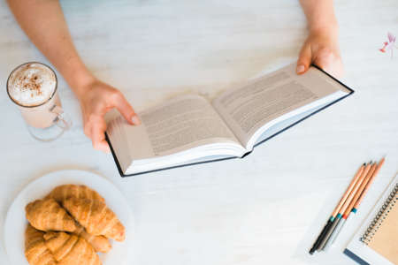 cozy composition of young beautiful girl reading a book ,the concept of leisure and Hobbiesの写真素材