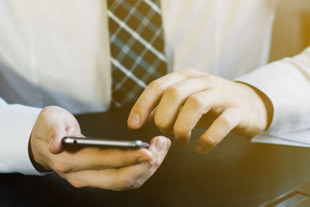 business concept, businessman working on workspace with smartphoneの写真素材
