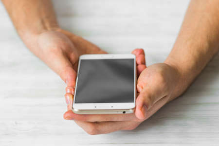 Man using white smartphone screen smart phone hands close upの写真素材