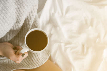 Breakfast. Pancakes with cream and coffee. Breakfast in the bed. Coffee time. Homemade. Girl is eating the lunch. Christmas morning. Lifestyle. copy space top view Yellow lightの写真素材