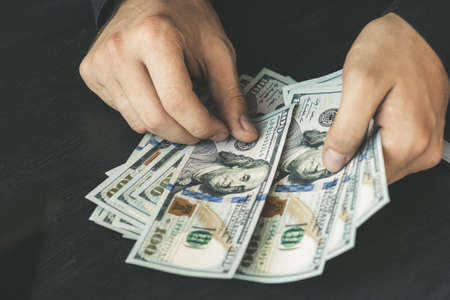 hand recount dollars. the man counts the money. new hundred-dollar billsの写真素材