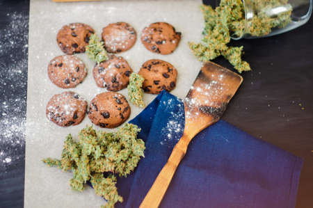 Cookies with cannabis and buds of marijuana on the table.の写真素材