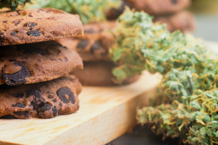 Cookies with cannabis and buds of marijuana on the table.の写真素材