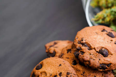 Cookies with cannabis and buds of marijuana on the table.の写真素材