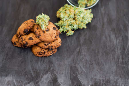 Cookies with cannabis and buds of marijuana on the table. Concept of cooking with cannabis herb. Treatment of medical marijuana for use in food, On a black background Copy Space CBD useの写真素材