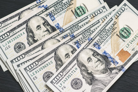 Dollars banknotes on black background.