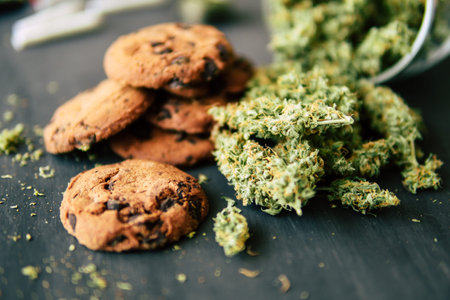 Cookies with cannabis and buds of marijuana on the table. Copy SpaceConcept of cooking with cannabis...