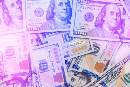 A large number of new hundred-dollar disintegrated one hundred US dollar bills.