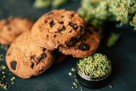 Cookies with cannabis and buds of marijuana on the table. Concept of cooking with cannabis herb....
