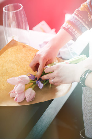 Florist holding a white and green bouquet for the bride. Job florist. Florist makes gentle spring...