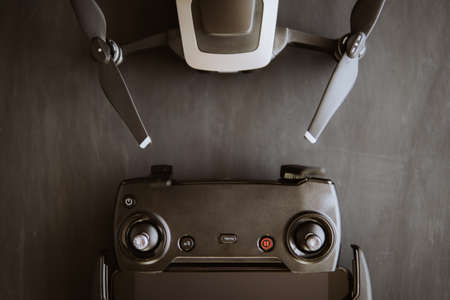 Copy space. Innovation photography concept. Mate color. A new black drone on a black table. The concept of using drones in life and industry. Close up Top view Remote control macro Details.の写真素材