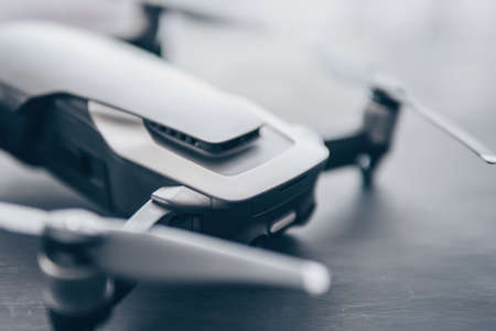 Innovation photography concept. Mate color. A new black drone on a black table. Mate color. The concept of using drones in life and industry. Close up drone Engines and blades macro Details. Copy space.の写真素材