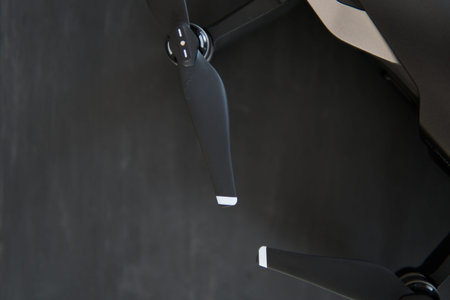 Copy space. Innovation photography concept. Mate color. A new black drone on a black table. The concept of using drones in life and industry. Close up drone Engines and blades macro Details.の写真素材