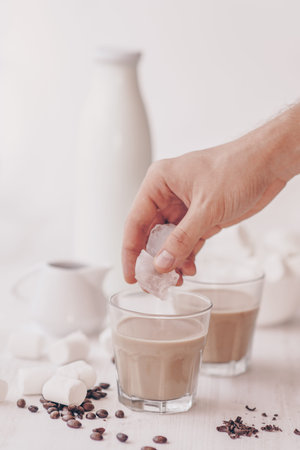 Cold coffee with milk and chocolate. Light background. Iced coffee. Concept of a cooling drink....