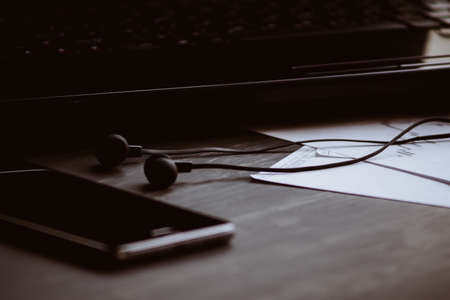 Top view. Macro shot of Smartphone and Laptop black background. Mate moody color. concept of work.の写真素材
