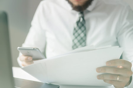 Businessman uses a smartphone. Office work concept. White background. Shopping online. sending...