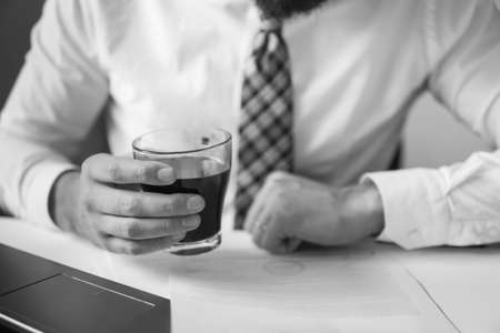 Businessman working with documents sending email, mobile phone. Businessman uses a smartphone. Office work concept. Black and white. White background.の写真素材