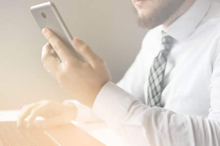 Smartphone and Internet Commerce. Payment online. Online trading. Young businessman Smartphone in his hands Online payments through the phone.の写真素材
