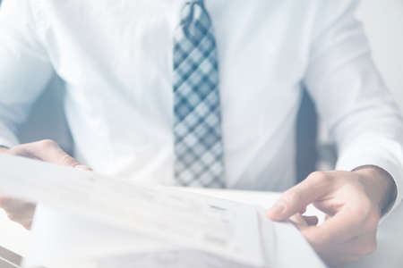 Businessman uses a smartphone Close up telephone. Sending email, mobile phone. Office work concept. Shopping online. Businessman working with documents White background.の写真素材