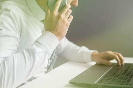 Online payments through the phone. Young businessman Smartphone in his hands. Online trading. Payment online. Smartphone and Internet Commerce.の写真素材