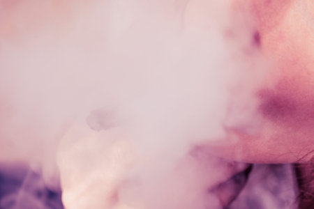 cannabis weed, a joint in his hands A woman smokes . Smoke on a black background. Concepts of...
