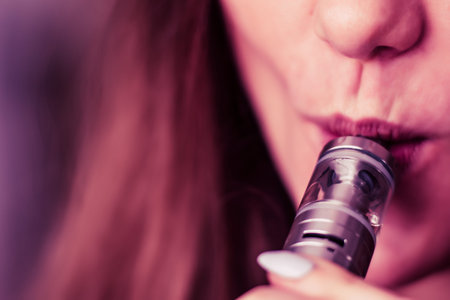 young woman smoking electronic cigarette