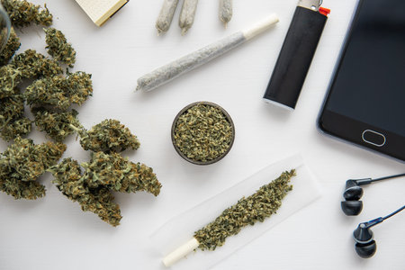 close up, Cannabis buds on black table, joint with marijuana, grinder with fresh weed ,
