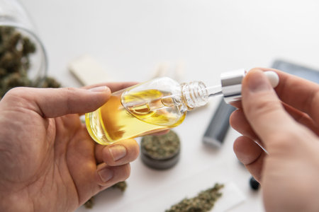 CBD cannabis OIL on white background, medical marijuana concept, close up, bottle of oil Cannabis in...