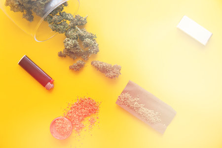 Background for Copy space. Hemp legalisation. Fresh marihuana. Top view. Cannabis buds on yellow...