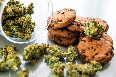 Cookies with cannabis herb CBD. Treatment of medical marijuana for use in food, white background....