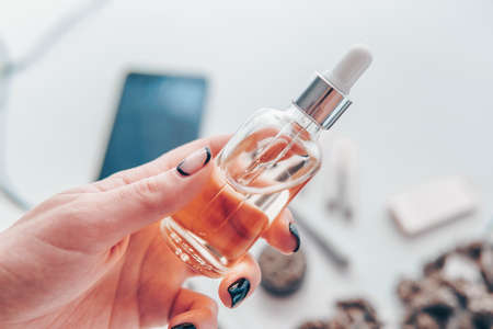close up, weed product, medical hemp concept, oil Cannabis CBD in pipette women hand, marijuana extract on white background,の写真素材