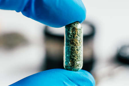 Pills with cannabis in the hands. The concept of taking hemp in food. Cannabis Oncology Treatment. close upの写真素材